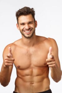 Handsome charming bearded young guy with naked torso, perfect body six-pack, finish workout, thanking instructor, show thumbs-up and smiling in approval, give positive feedback about gym, exercises.